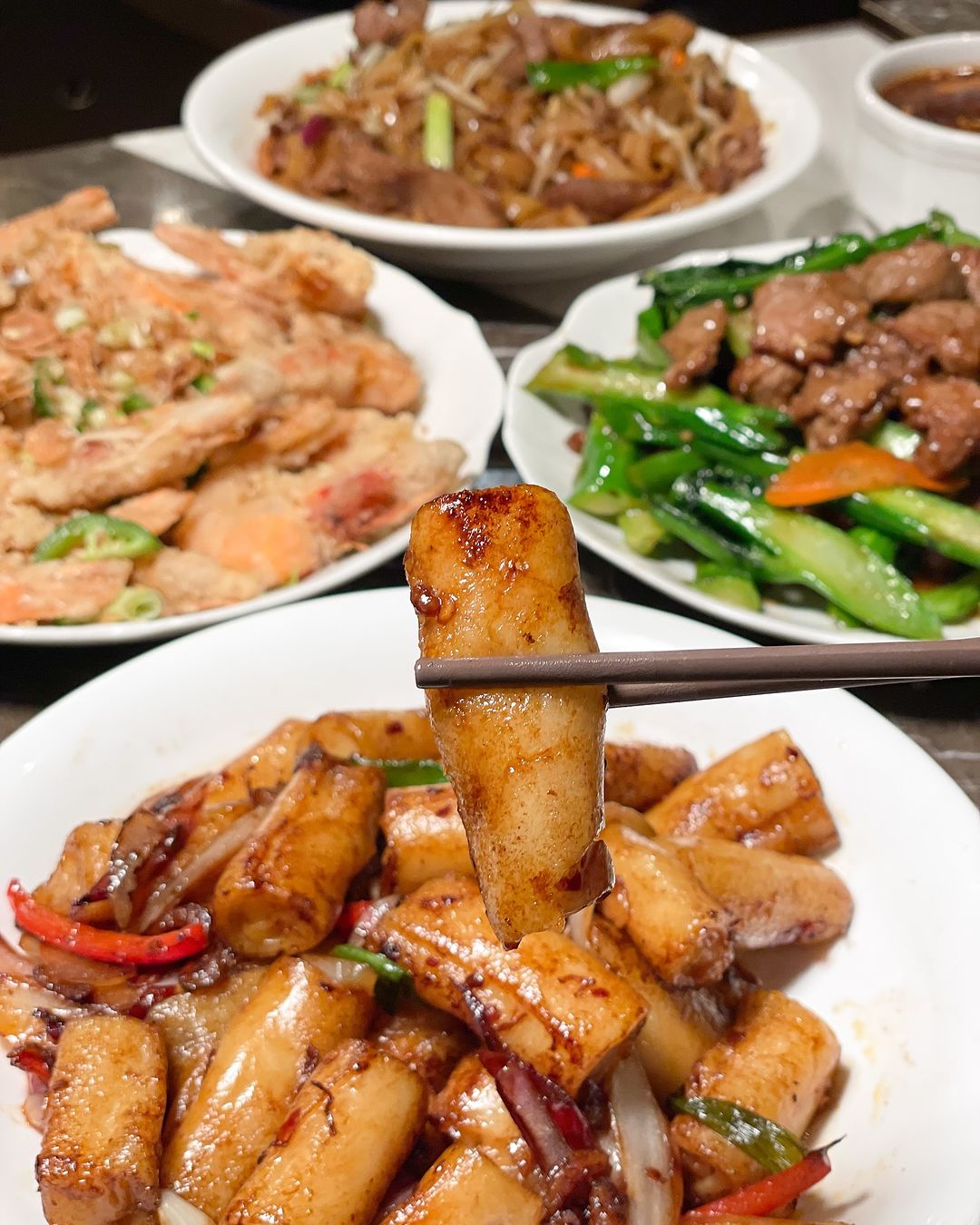 MingHin rice noodle rolls with a spread of Cantonese dishes